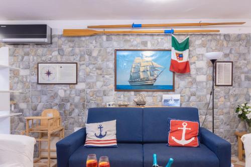 a living room with a blue couch with pillows on it at Marinautica Sea Cottage in Sorrento
