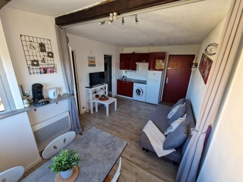 un petit salon avec un canapé et une table dans l'établissement Agréable T2 à 2 pas de la plage, à Narbonne-Plage