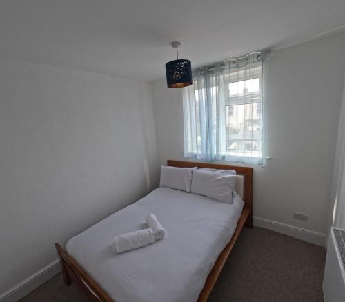 a small bedroom with a bed with a pillow on it at Double Room With Gym Access in Portsmouth