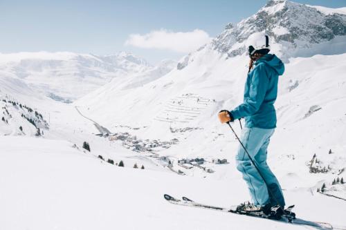 a man on skis on a snow covered mountain at Appartement in the middle of Zürs/ Skiarlberg in Zürs am Arlberg