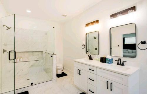 a white bathroom with a shower and a sink at Luxurious 3+1 Villa in Dallas in Dallas