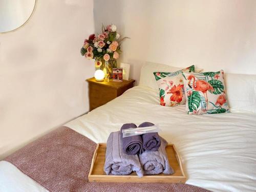 a tray on a bed with towels and a bouquet of flowers at Tower Bridge Borough Market London Bridge House in London