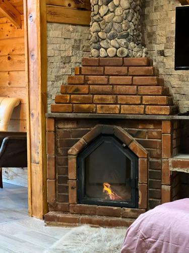 a brick fireplace in a room with stairs at Peruma otel bungalov in Çamlıhemşin