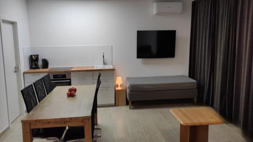 a small living room with a table and a couch at Eleonoras Ferienwohnung in Würzburg Stadt inklusive eigenen Parkplätzen vor der Tür in Würzburg
