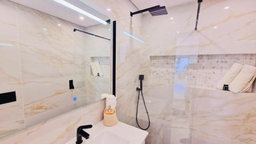 a bathroom with a shower and a white sink at Your dream Getaway Awaits in Vale do Lobo in Almancil