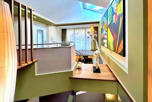 a room with a desk and a large painting on the wall at Grütter Luxury Apartments in Ischgl