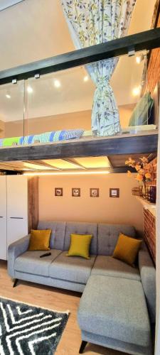 a living room with a couch with yellow pillows at Old Town #Menorah #MostCity in Dnipro