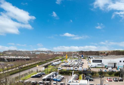 a parking lot filled with parked cars in a parking lot at B&B HOTEL Calais Terminal Cité Europe 3 étoiles in Coquelles