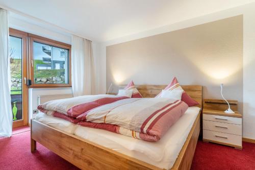 a bedroom with a bed and a window at Ferienwohnung Schwarzwald in Baiersbronn