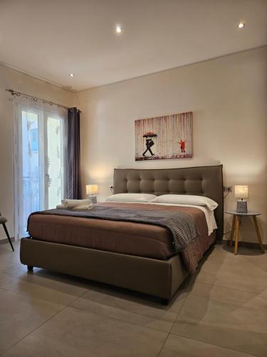 a bedroom with a large bed with two lamps at La Rosa del lago in Stresa