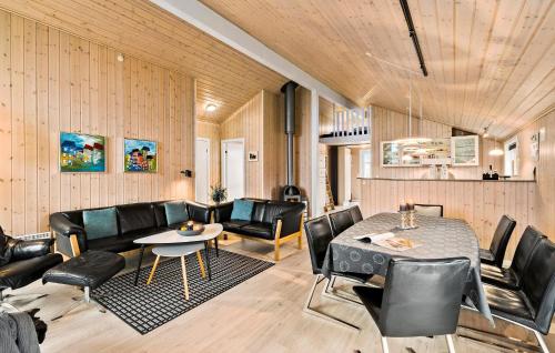 a living room with a table and leather chairs at Holiday Home Fasanvænget Hemmet I in Hemmet