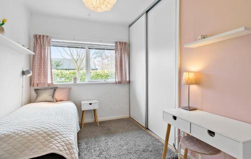 a bedroom with a bed and a mirror at Amazing Home In Roskilde With Kitchen in Roskilde