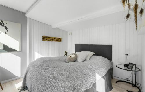 a bedroom with a bed with a teddy bear on it at Two-Bedroom Holiday Home In Jagerspris in Jægerspris