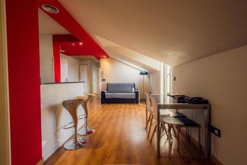 a room with a table and chairs and a couch at Apartamentos Spa Villa Pasiega in Hoznayo