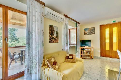 a living room with a couch and a table at House ROSSELLA with cozy apartment and rooms close to the beach in Nerezine