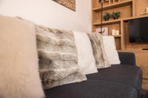 a blanket on a couch in a living room at Aparthotel Herzblick GmbH in See