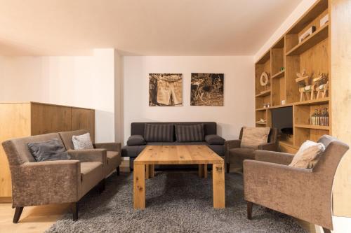 a living room with a couch and a table at Aparthotel Herzblick GmbH in See