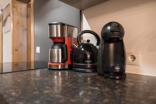 a coffee maker and a blender sitting on a counter at Aparthotel Herzblick GmbH in See