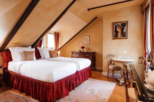 a bedroom with two beds and a table in it at Alchymist Grand Hotel and Spa - Preferred Hotels & Resorts in Prague