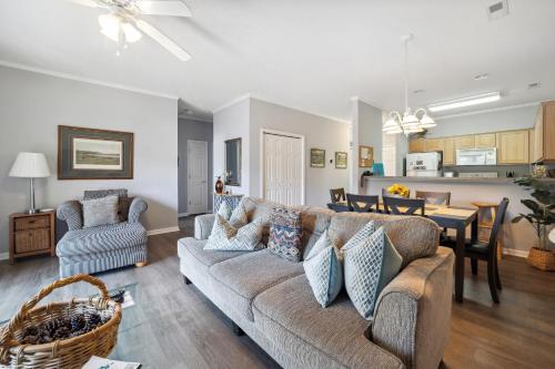 a living room with a couch and a dining room at Riverside Relaxation – Golf, Beach & More - Little River, South Carolina in Little River