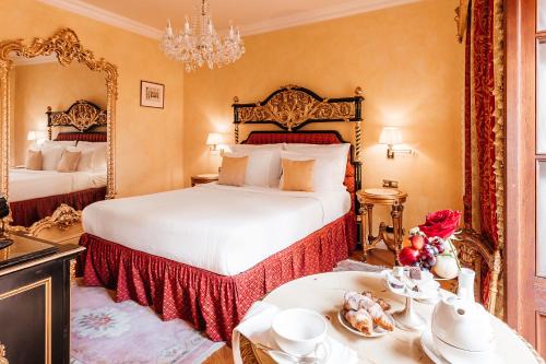 a bedroom with two beds and a table with food at Alchymist Grand Hotel and Spa - Preferred Hotels & Resorts in Prague