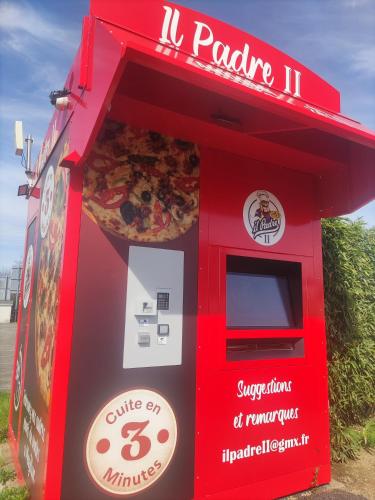 a red pizza machine with a large pizza at Premiere Classe Vannes in Vannes
