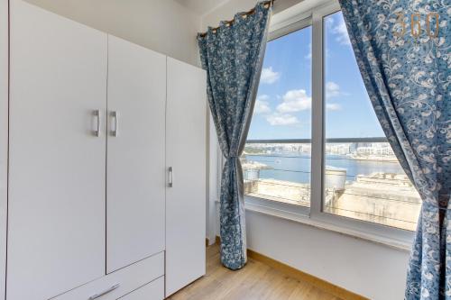 a room with a window with a view at Charming home with Sea views & Maltese Balcony by 360 Estates in Valletta