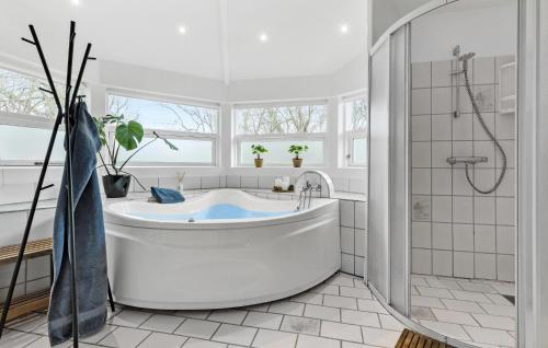 a white bathroom with a tub and a shower at Pet Friendly Home In Knebel With Wifi in Knebel