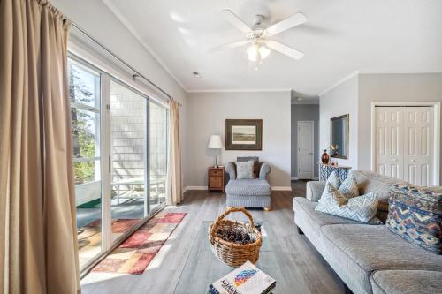 a living room with a couch and a ceiling fan at Riverside Relaxation – Golf, Beach & More - Little River, South Carolina in Little River