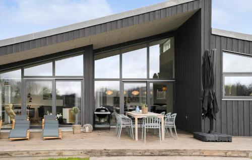 a house with glass doors and a table and chairs at Nice Home In Haderslev With Kitchen in Haderslev