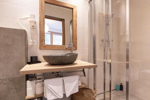 a bathroom with a sink and a shower at Aparthotel Herzblick GmbH in See
