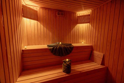a sauna with a bench in a sauna at Hotel Xaluca Spa Aguelmame Sidi Ali in Aguelman
