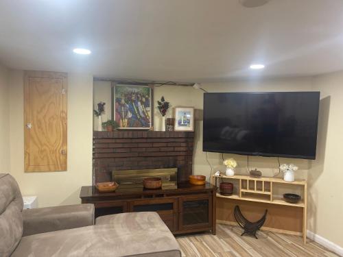 a living room with a large flat screen tv at Welcome to Malden - Boston in Malden