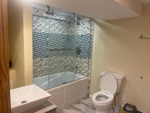a bathroom with a shower and a toilet and a sink at Welcome to Malden - Boston in Malden