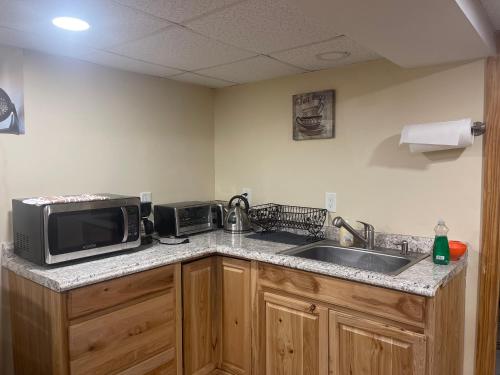 a kitchen with a microwave and a sink at Welcome to Malden - Boston in Malden