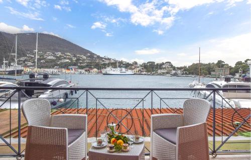 a balcony with chairs and a view of a marina at 2 Bedroom Amazing Apartment In Ischia in Ischia