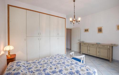 a bedroom with a bed and a table and a desk at 2 Bedroom Amazing Apartment In Ischia in Ischia