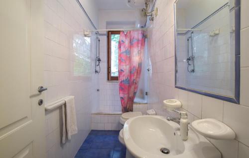a bathroom with a sink and a toilet and a mirror at 2 Bedroom Amazing Apartment In Ischia in Ischia