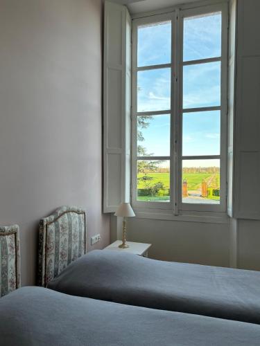 una camera con letto e finestra di Chambre d'hôte double 2 a Castelsarrasin