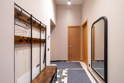a hallway with a bench in a locker room at Apartments with private parking & terrace in Jūrmala