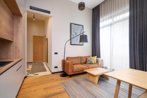 a living room with a couch and a table at Apartments with private parking & terrace in Jūrmala