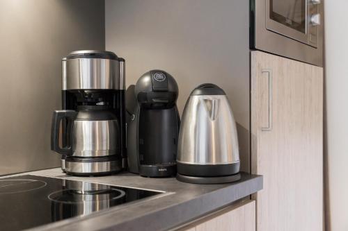 a coffee maker on a counter in a kitchen at Aparthotel Herzblick GmbH in See