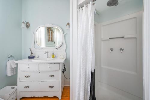 a white bathroom with a sink and a mirror at The Gables of Rhinebeck in Rhinebeck