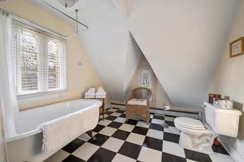 a bathroom with a white tub and a toilet at The Gables of Rhinebeck in Rhinebeck