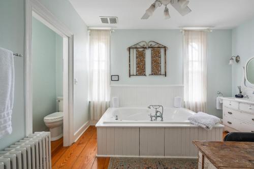 a white bathroom with a tub and a toilet at The Gables of Rhinebeck in Rhinebeck