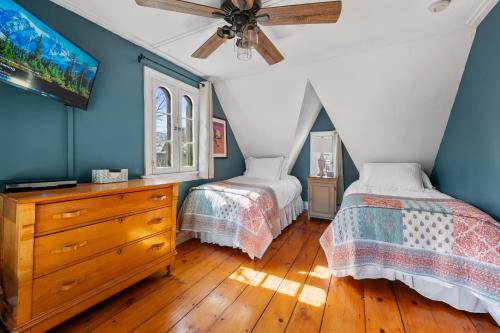 a bedroom with two beds and a ceiling fan at The Gables of Rhinebeck in Rhinebeck