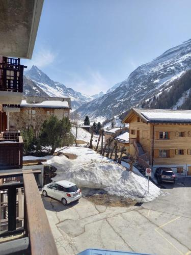 a car parked in a parking lot in front of a mountain at Studio aux Glaciers in Zinal