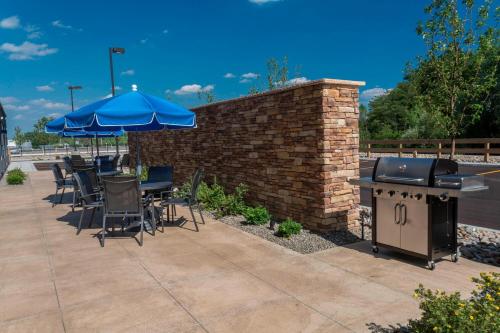 a patio with tables and chairs and an outdoor grill at Fairfield Inn & Suites by Marriott Geneva Finger Lakes in Geneva