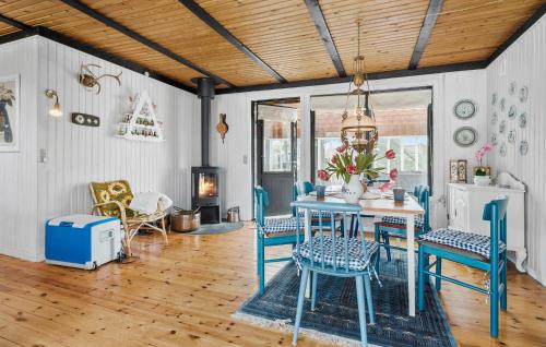 a dining room with blue chairs and a table at 3 Bedroom Gorgeous Home In Kalundborg in Kalundborg