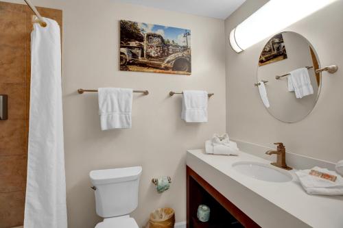 a bathroom with a sink and a toilet and a mirror at Coconut Mallory Resort and Marina in Key West